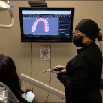 Patient and dentist looking at dental scan