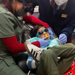 Our dentist cleaning a patients teeth
