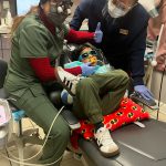 Our dentist cleaning a patients teeth
